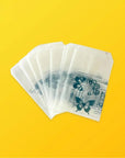 Custom glassine bags with butterfly prints on a yellow background, showcasing glossy finish and lightweight design.