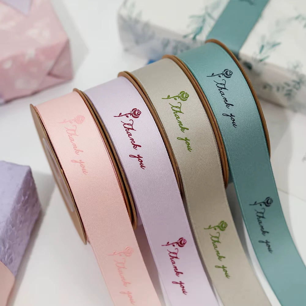 Custom polyester cotton ribbon in pastel colors with "Thank you" design, ideal for gift wrapping and decorating.