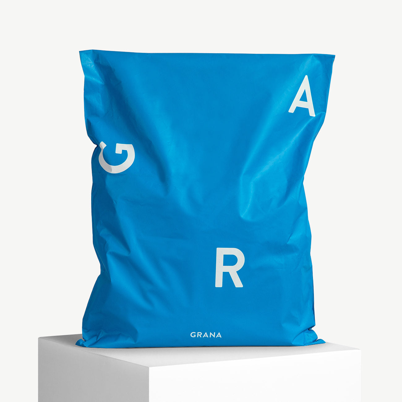 Custom blue poly mailer bag with bold white lettering, ideal for stylish and eco-friendly shipping solutions.