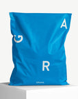 Custom blue poly mailer bag with bold white lettering, ideal for stylish and eco-friendly shipping solutions.