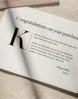 Custom congratulations card showcasing a brand story for customer purchases, featuring elegant typography and personal message.
