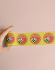 Custom round roll labels displayed with a design mockup, showcasing vibrant colors and professional presentation.
