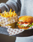 Custom deli paper featuring a burger and fries, showcasing food safe ink and stylish matte finish.