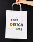 Custom white paper bag with space for personalized design, ideal for branding and gifting.