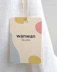 Custom hang tag featuring modern design with colorful shapes, ideal for boutique or artisan branding.