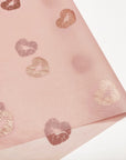 Custom pink tissue paper with gold heart and lip print, perfect for elegant packaging and branding.