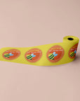 Custom round roll labels featuring colorful designs for packaging mockups on a yellow background.
