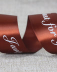 Custom satin ribbon in rich brown with "Just for you" message, perfect for elegant gift wrapping and decoration.