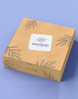 Custom square sticker mockup on a kraft box with floral design, showcasing personalized branding options.