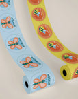 Custom round roll labels featuring colorful designs in blue and yellow mockup, ideal for enhancing product packaging.