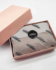 Custom tissue paper elegantly wrapped inside a pink gift box, enhancing brand presentation and unboxing experience.