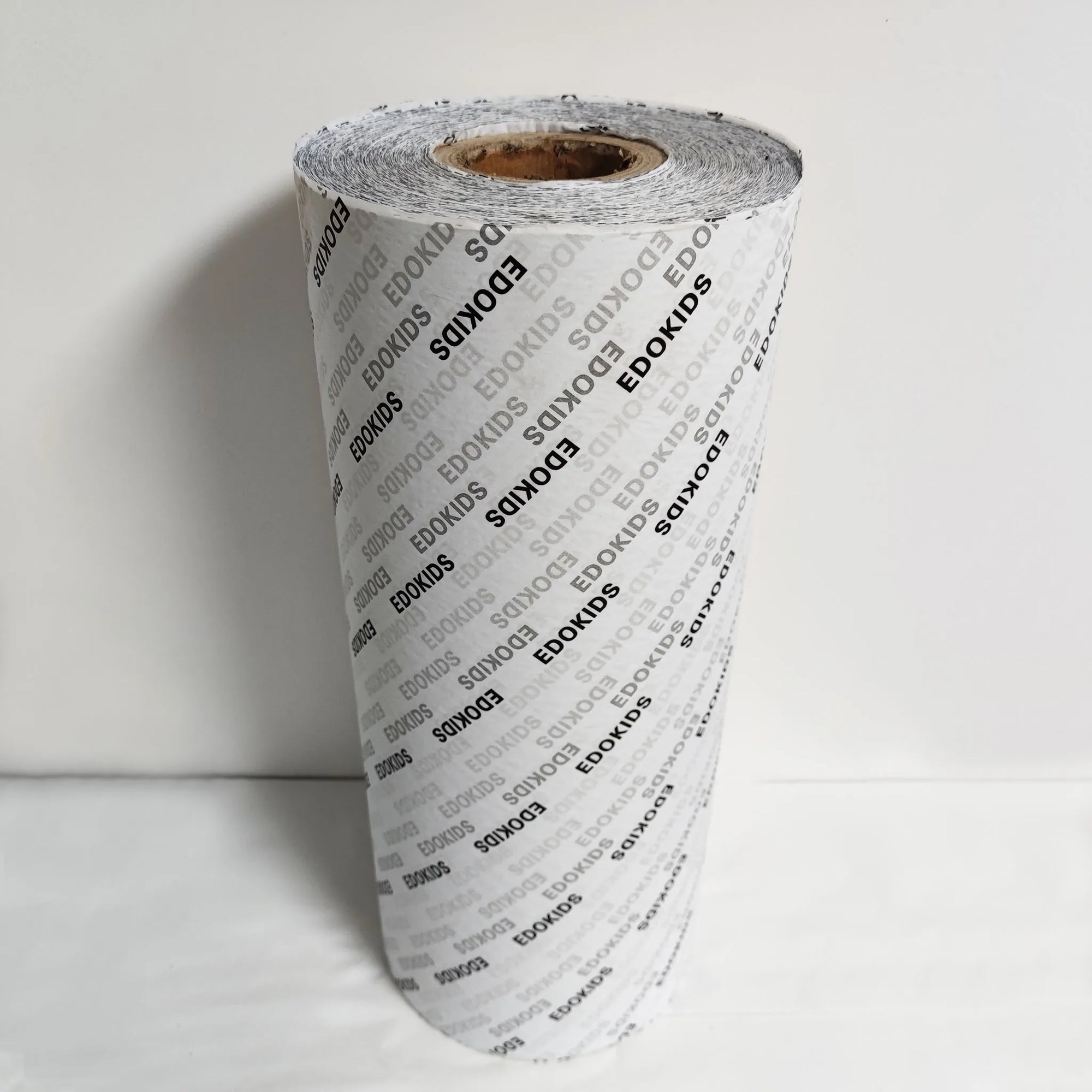Custom tissue paper roll showcasing eco-friendly design and personalized branding options for stylish packaging.