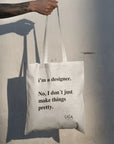 Custom tote bag featuring the quote "I'm a designer. No, I don't just make things pretty." on eco-friendly material.