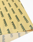 designed yellow tissue paper with green logo