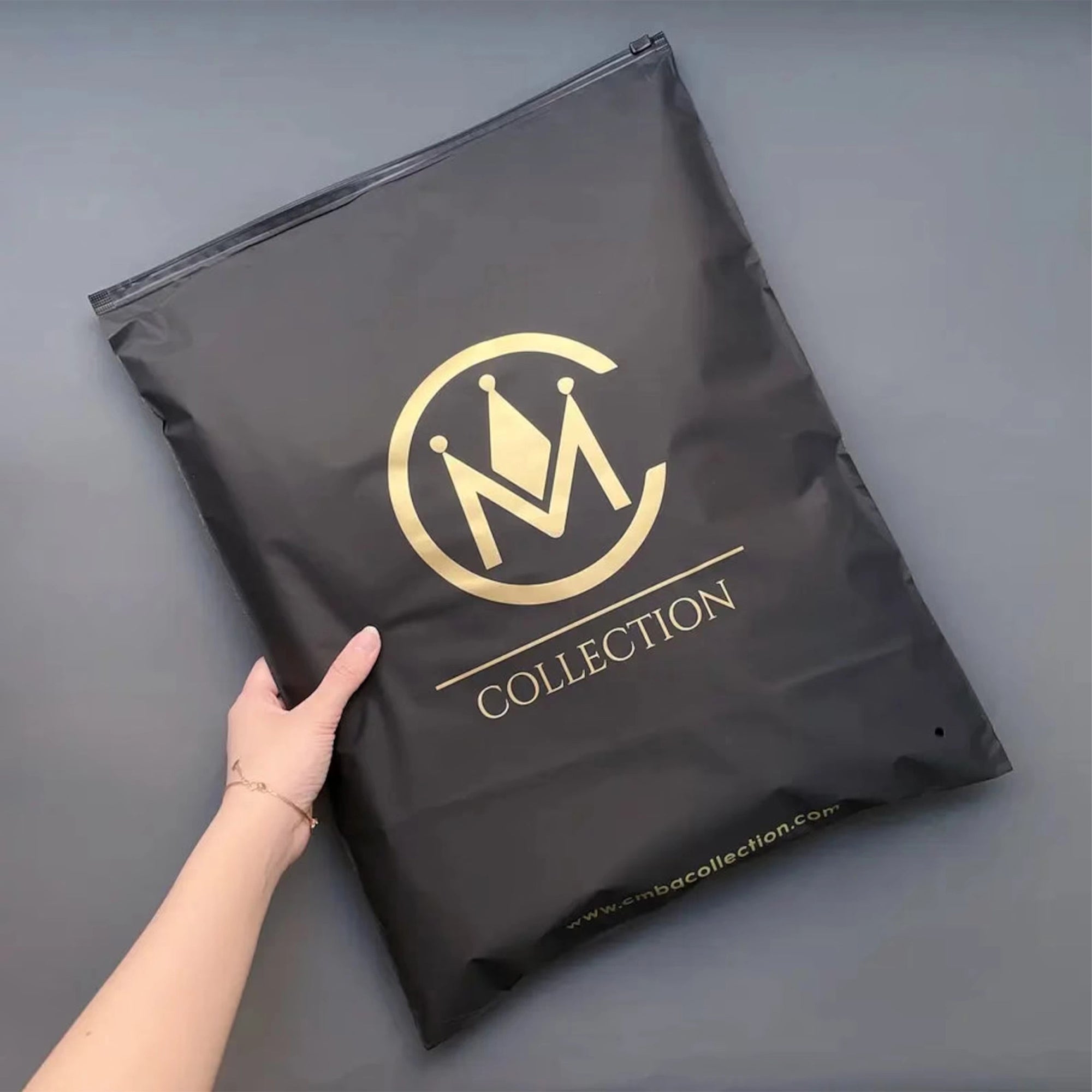 Custom black zipper bag featuring a gold logo, perfect for secure packaging and brand identity.