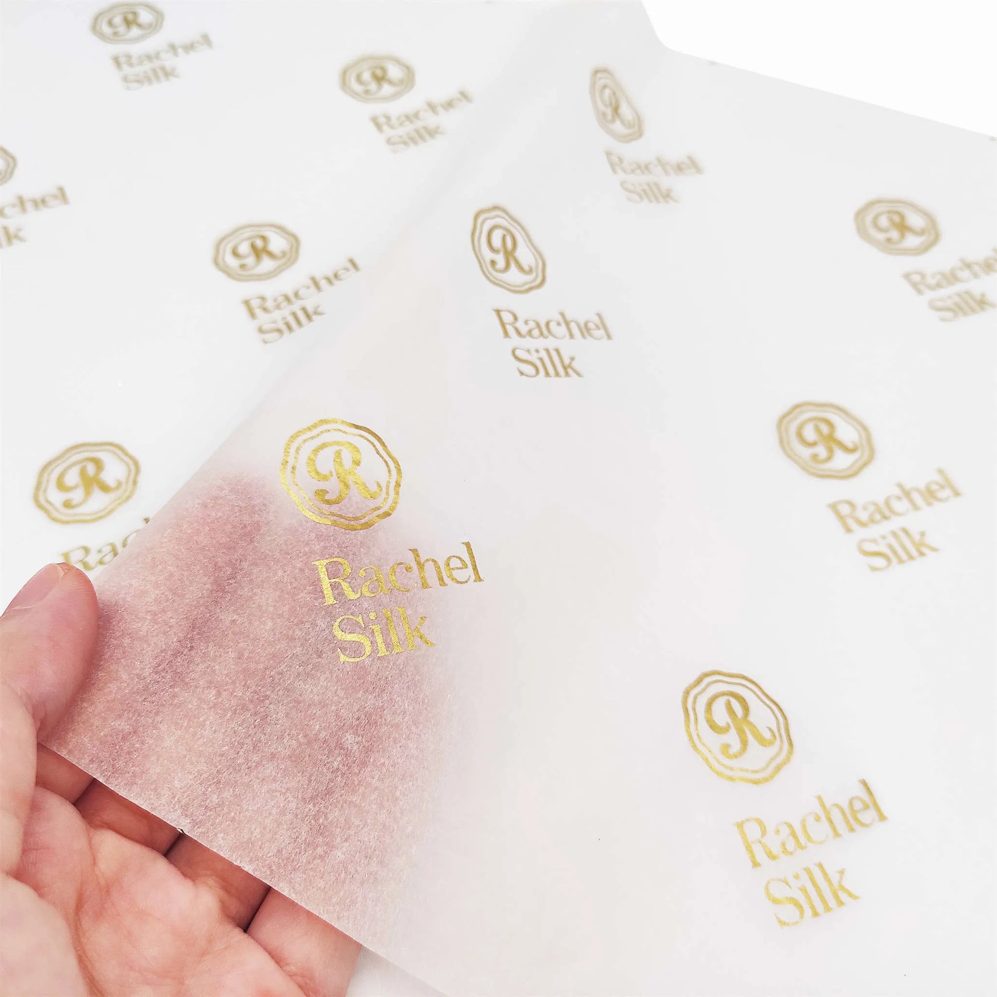 Custom tissue paper featuring elegant gold logos, enhancing branding and presentation for premium packaging.