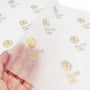 Custom tissue paper featuring elegant gold logos, enhancing branding and presentation for premium packaging.