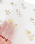 Custom tissue paper featuring elegant gold logos, enhancing branding and presentation for premium packaging.