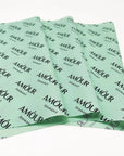 Custom tissue paper in mint green featuring "AMOUR" branding for elegant packaging and enhanced unboxing experience.