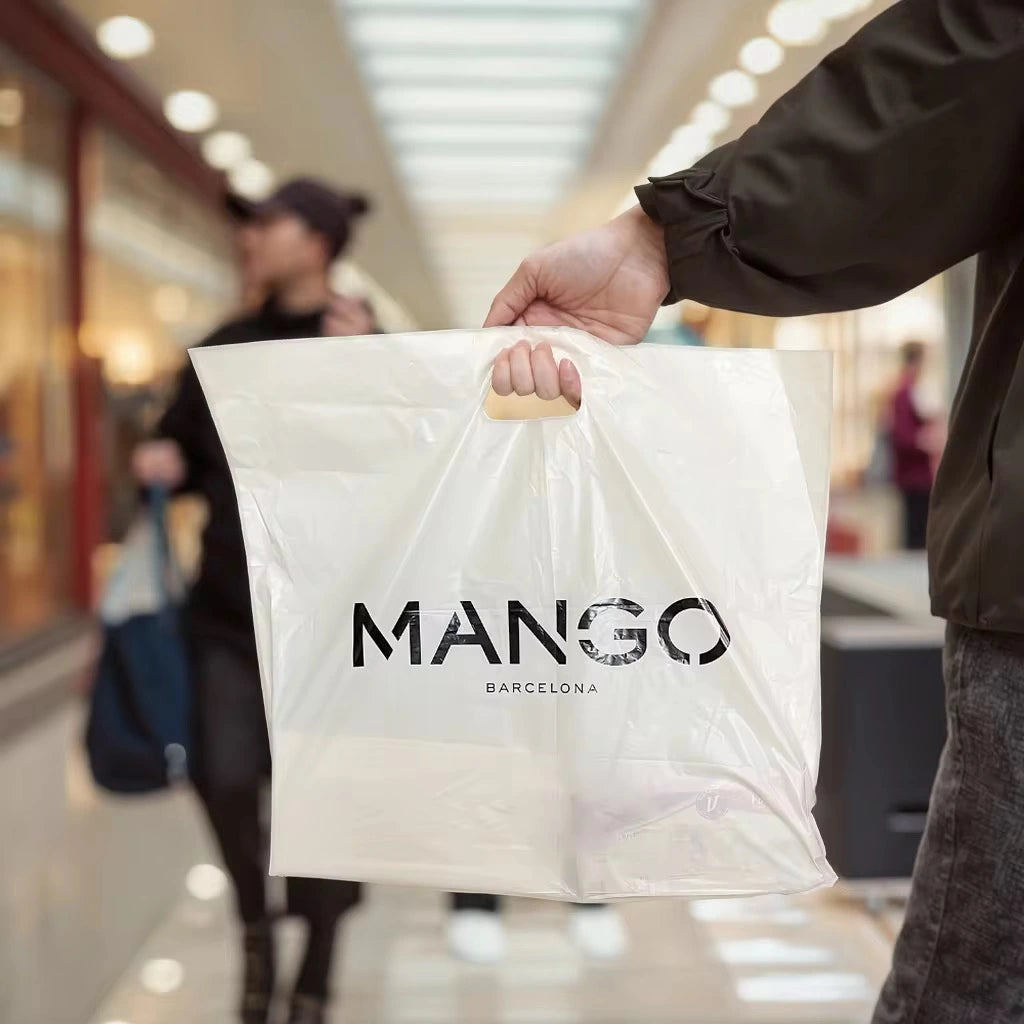Custom die cut handle bag featuring the Mango Barcelona logo, ideal for retail and branding opportunities.