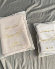 Two frosted zipper bags in beige and white, showcasing 'Supreme Glo' branding, ideal for cosmetics packaging.