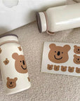 Custom bear-themed stickers and a matching bottle, showcasing cute bear designs for playful branding.