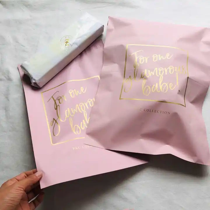 Custom pink poly mailers with gold lettering, perfect for stylish branding and secure e-commerce shipping.