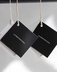 Custom hang tags in black and white for professional branding. Perfect for boutique or artisan use.