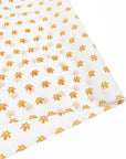 Custom tissue paper with a delicate floral pattern in orange and white, ideal for elegant packaging and branding.