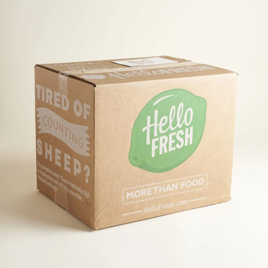 Custom shipping box from HelloFresh with green logo and text promoting meal delivery.