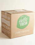 Custom shipping box from HelloFresh with green logo and text promoting meal delivery.