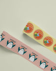 Custom round roll labels featuring colorful designs with bees and playful characters on a soft background.