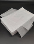 Stack of eco-friendly bulk tissue paper sheets on a black background, ideal for packaging and gifting.