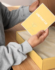 Person holding a custom card with a floral design, ready to include in unique product packaging.
