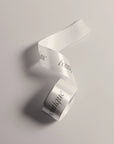 Custom satin ribbon with elegant printed text, ideal for gifts and event decorations.