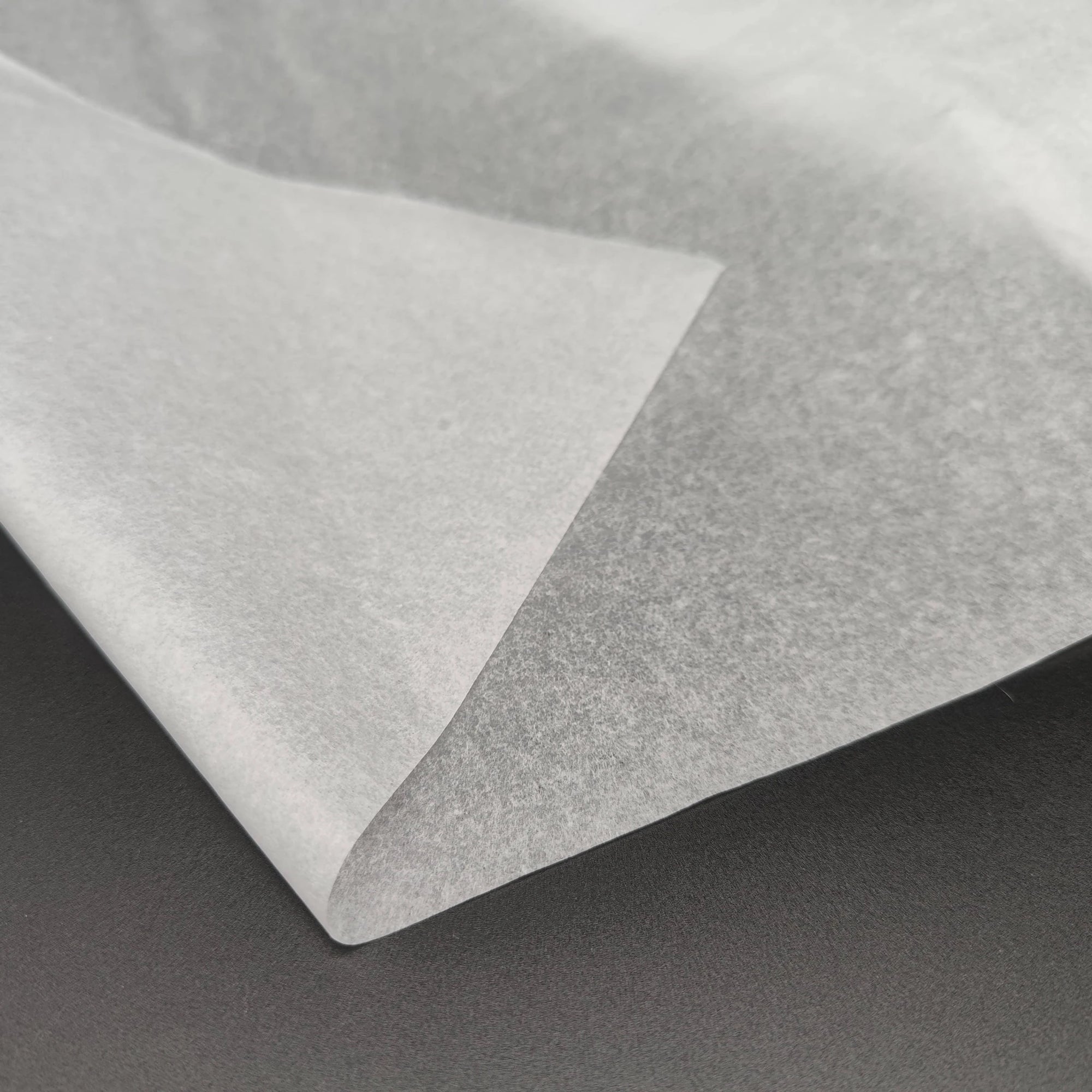 Close-up of eco-friendly bulk tissue paper, showcasing its soft, high-quality texture for packaging applications.