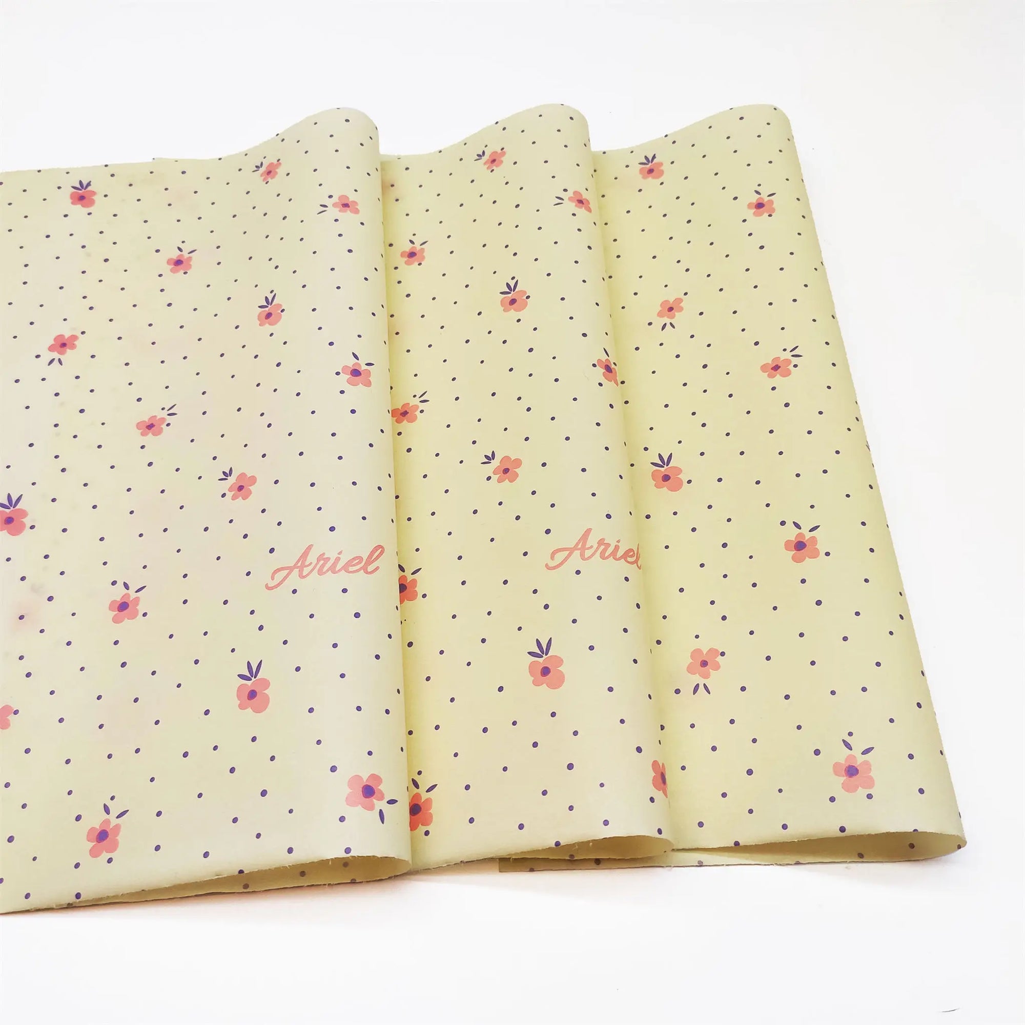 yellow tissue paper printed with flowers logo