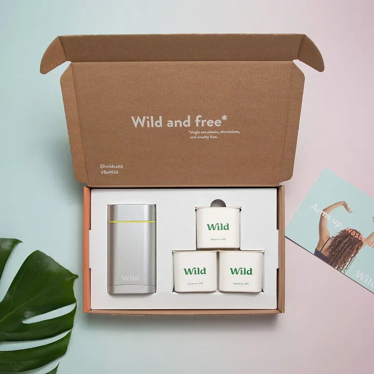 PR package featuring a silver container and three candles, all labeled 'Wild' in a kraft box with a motivational message.