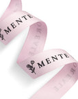 Custom pink polyester cotton ribbon featuring the word "MENTE" and floral design, perfect for branding and gift wrapping.