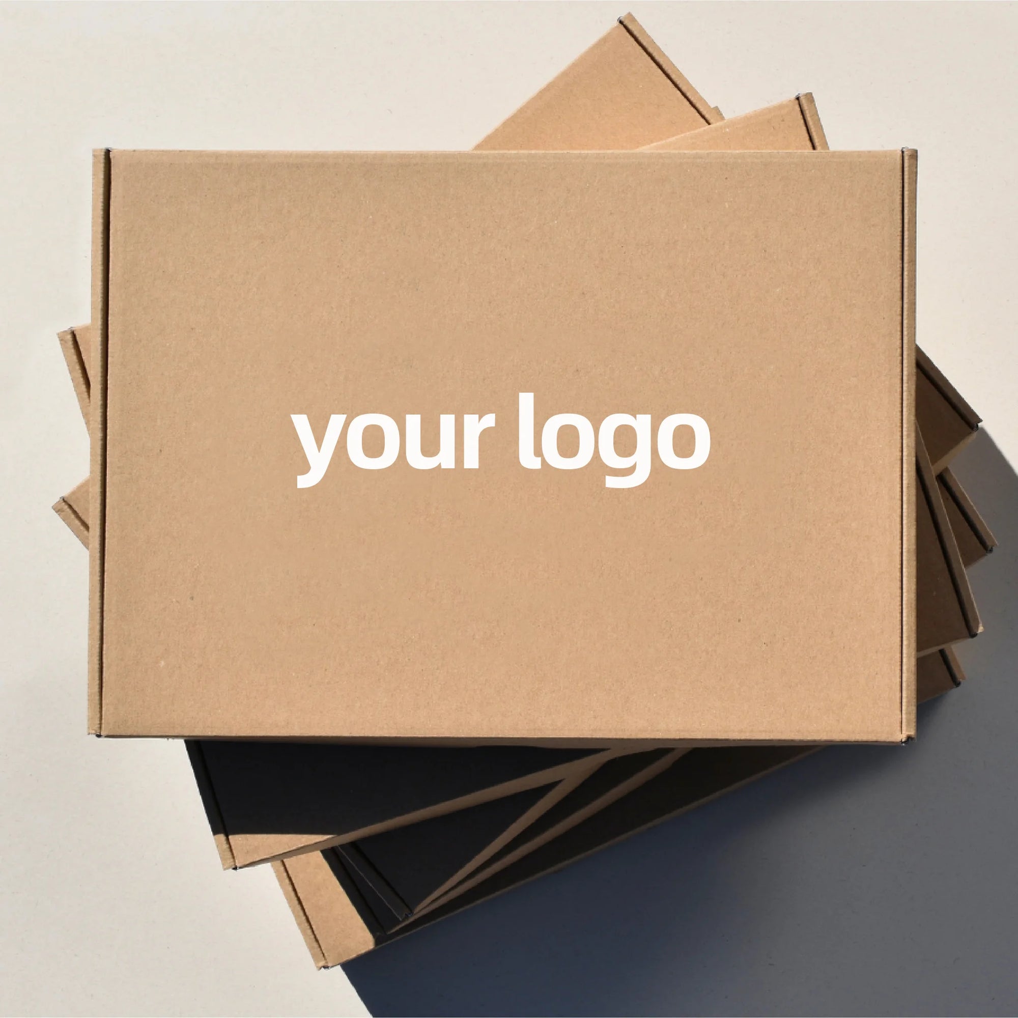Custom mailer box featuring a logo on a kraft surface, ideal for branding and packaging solutions.