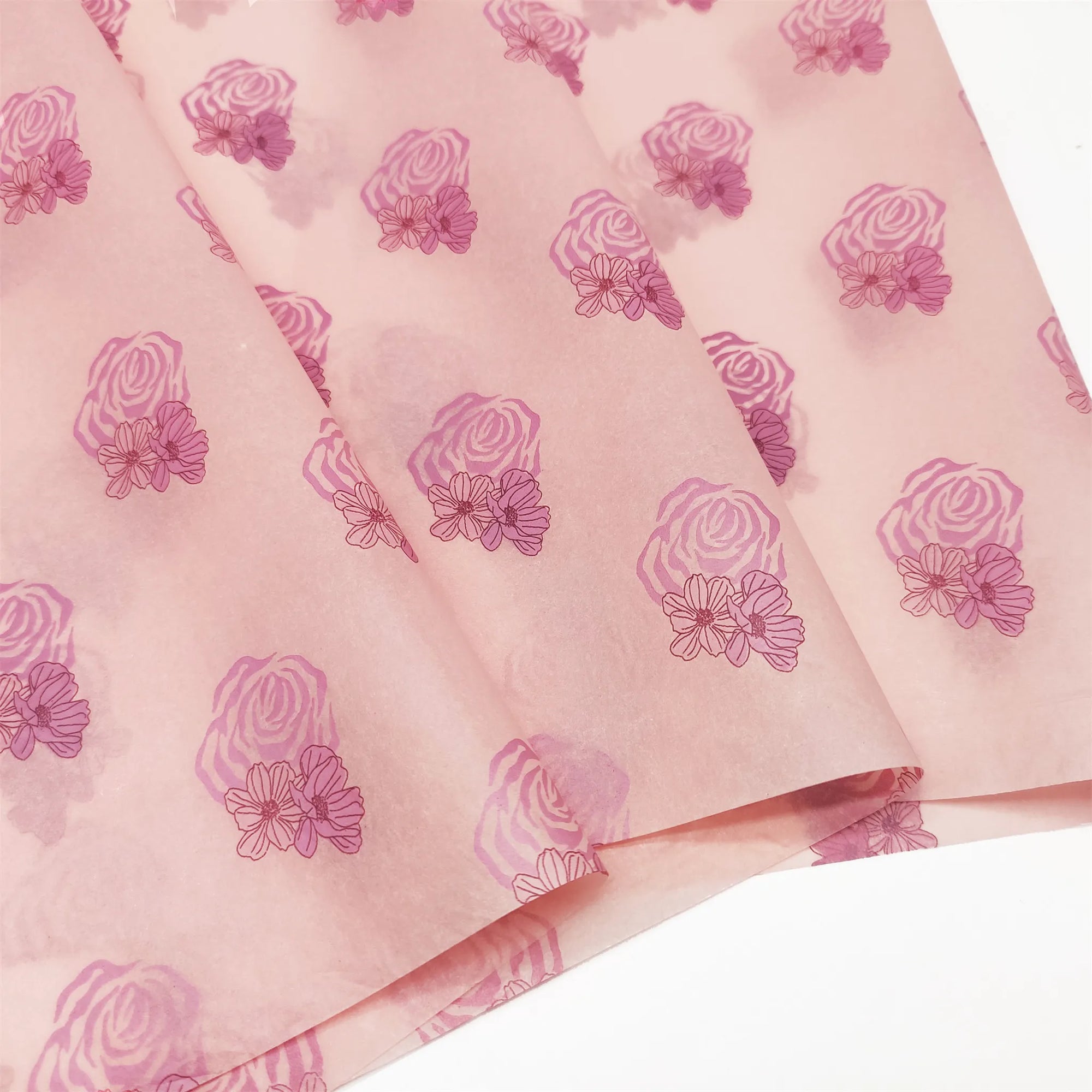 Custom tissue paper featuring pink rose and floral designs, ideal for elegant branding and packaging solutions.