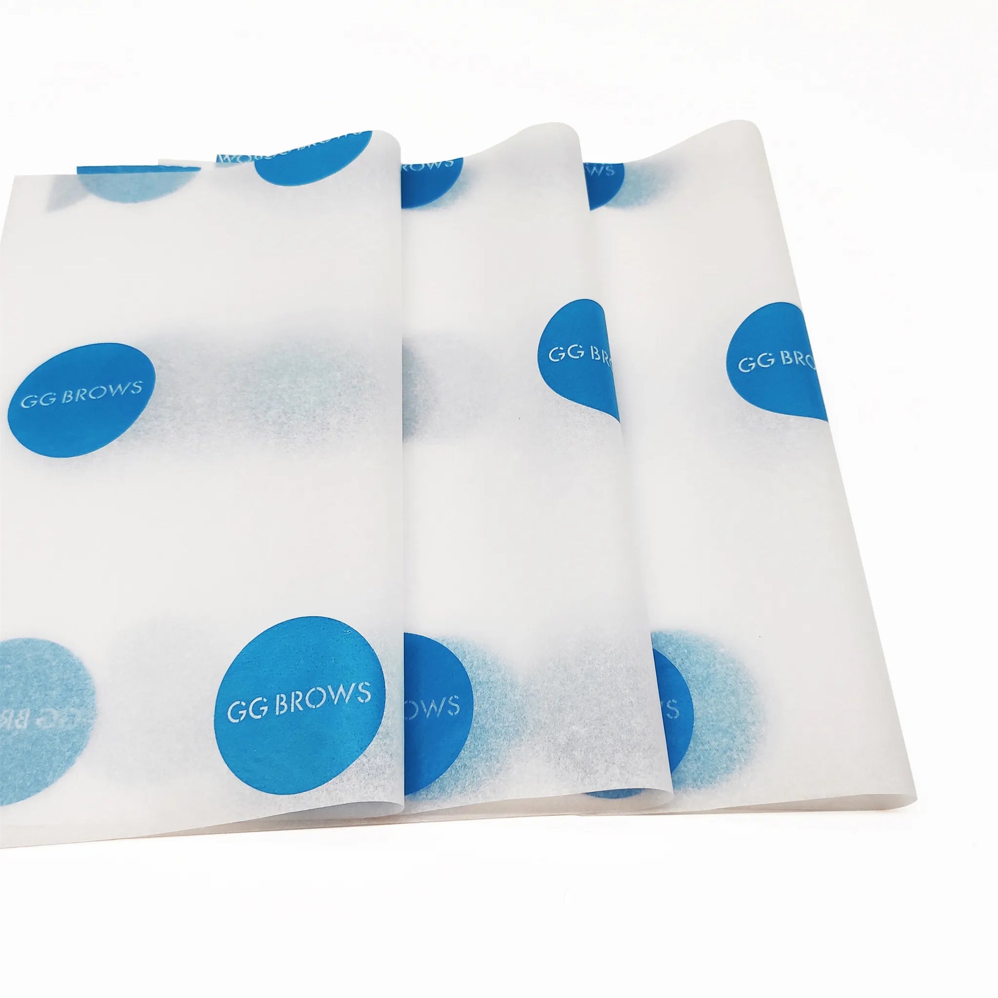 Custom tissue paper featuring blue GG BROWS logo on a white background, enhancing product packaging and branding.