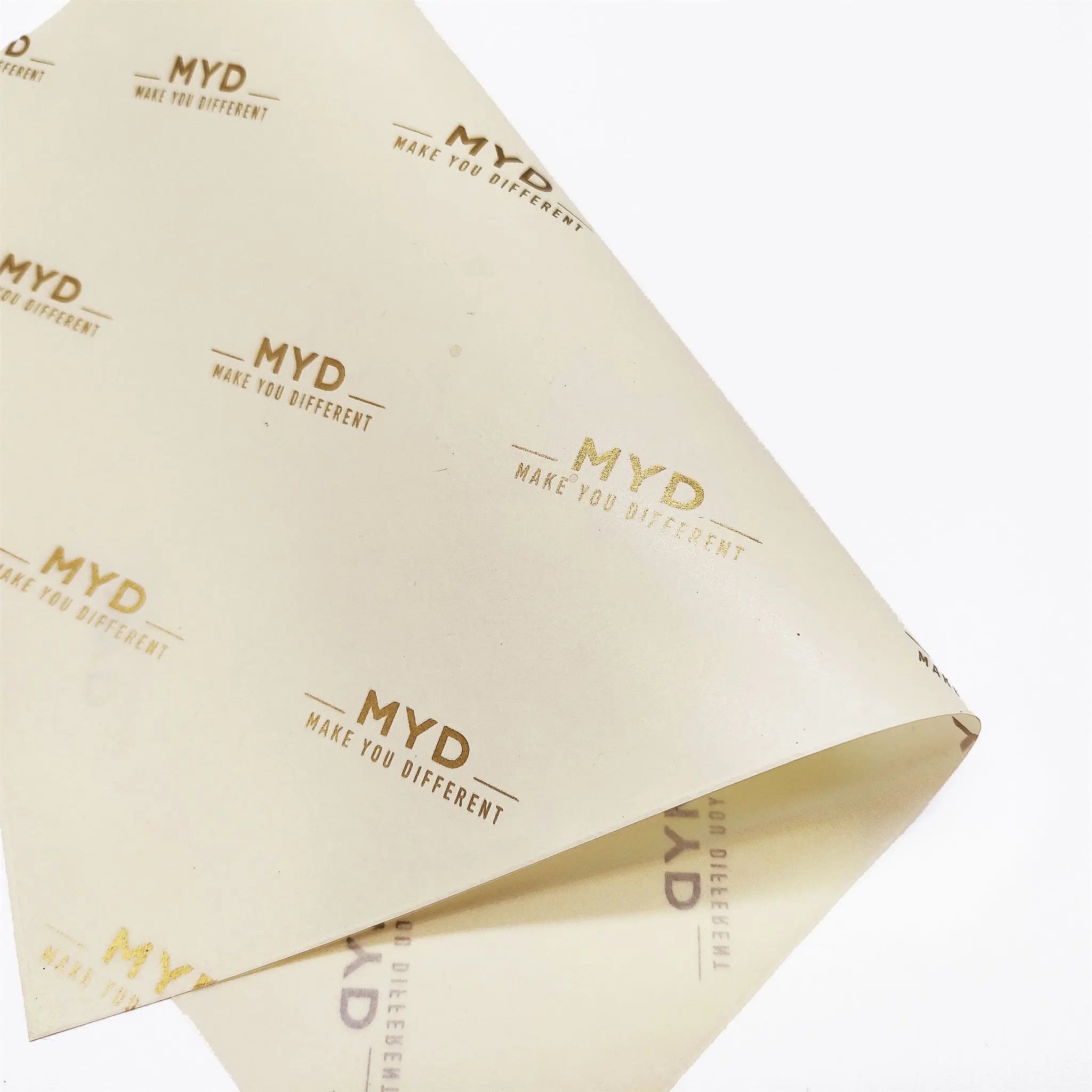 light yellow tissue paper branded with gold logo
