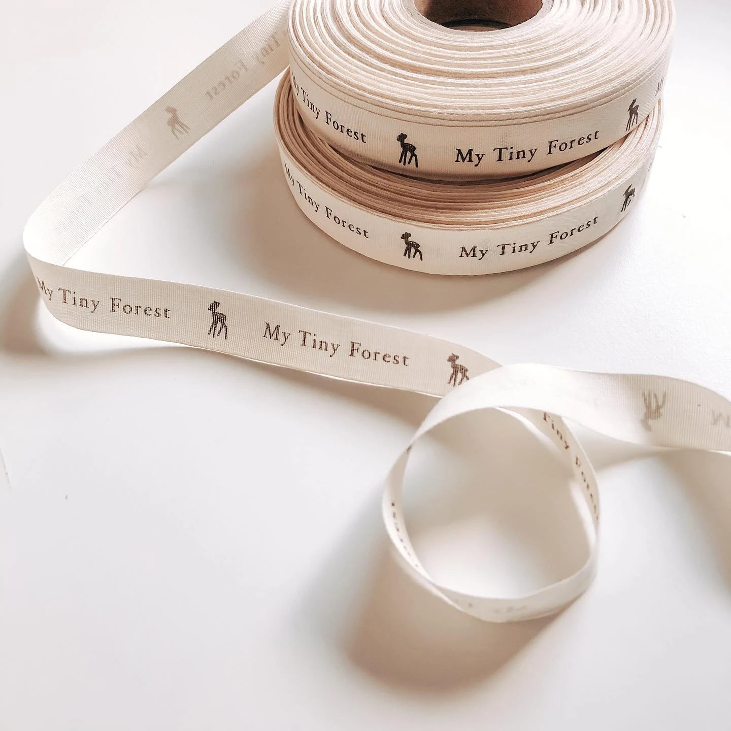 Custom cotton ribbon in natural tones with &quot;My Tiny Forest&quot; text and graphic, perfect for sustainable packaging and crafts.