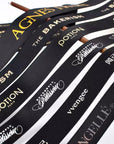 Custom grosgrain ribbon featuring various logos in black and white, showcasing its stylish and durable design.