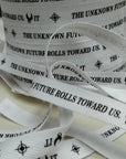 Custom herringbone ribbon featuring the phrase "The Unknown Future Rolls Toward Us" in black on a white background.