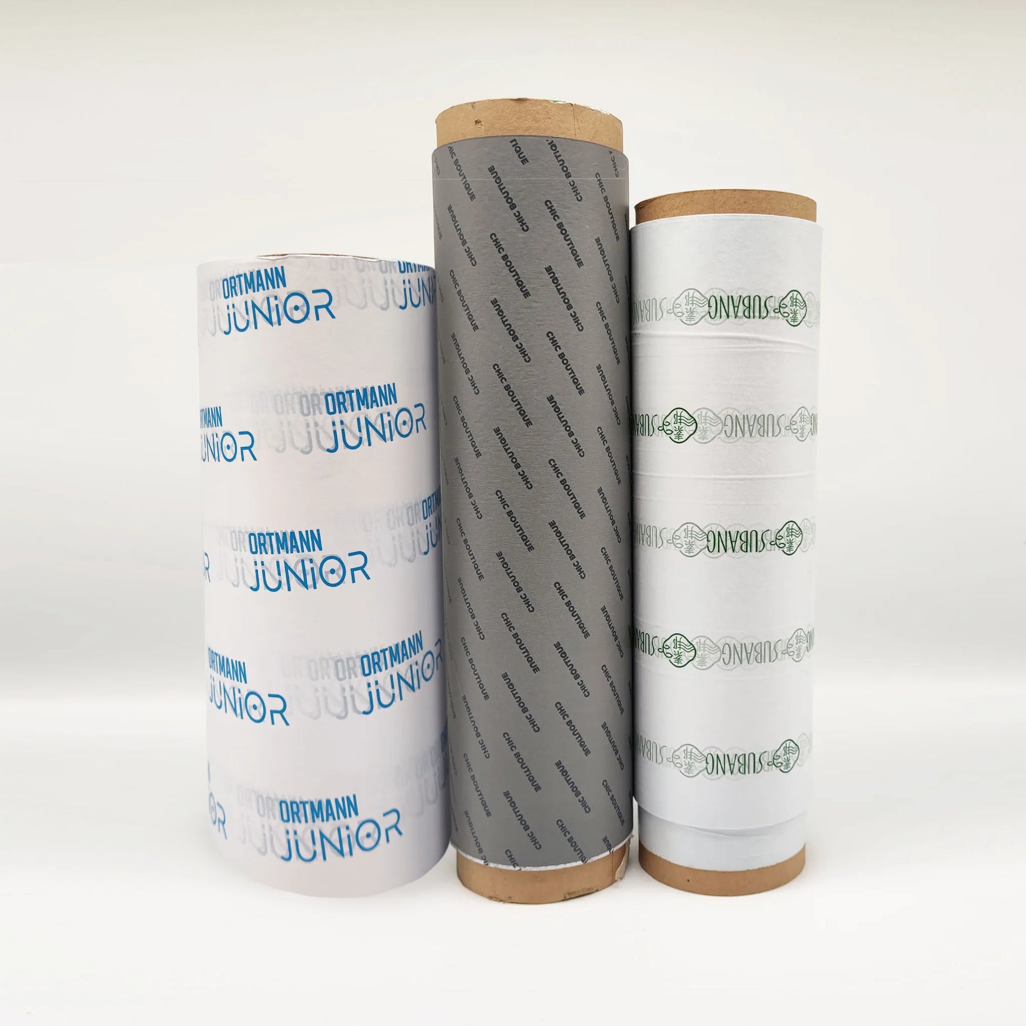 Custom tissue paper rolls in various designs, showcasing brand logos and colors for stylish packaging solutions.