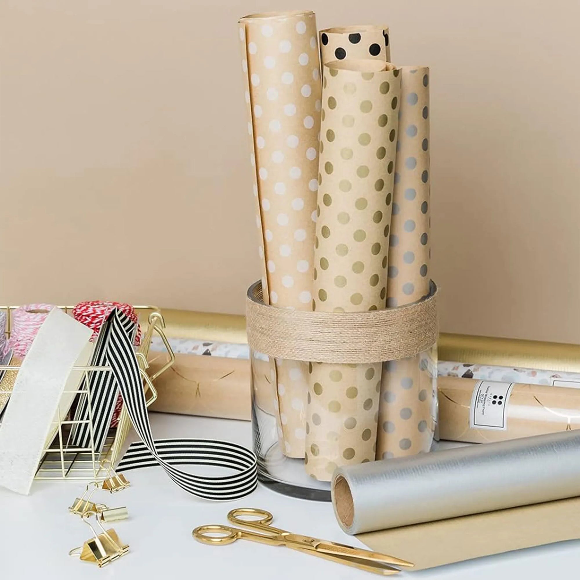 Custom tissue paper rolls in a glass holder showcasing polka dot designs, perfect for stylish packaging solutions.
